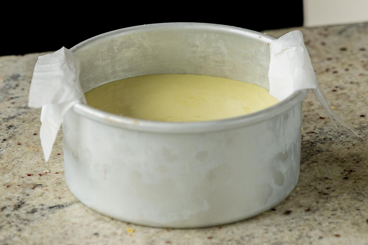 adding frosting to the first cake layer