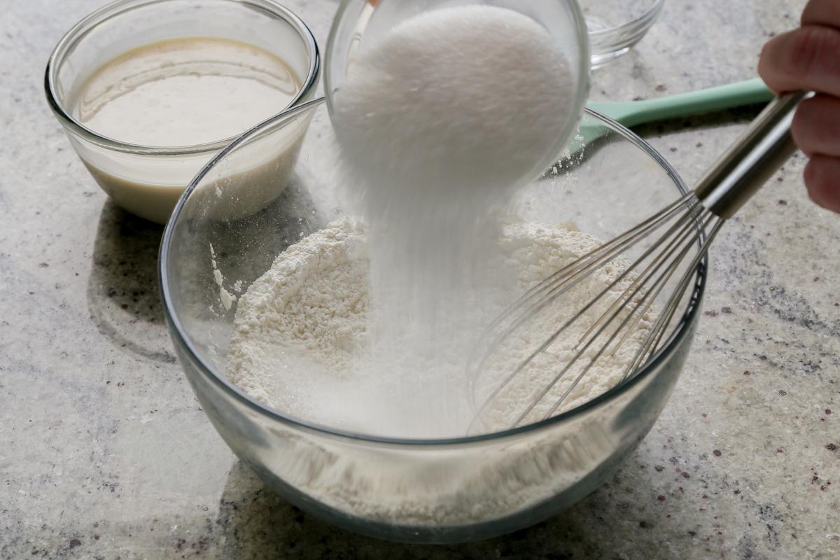 adding dry ingredients to the mixing bowl