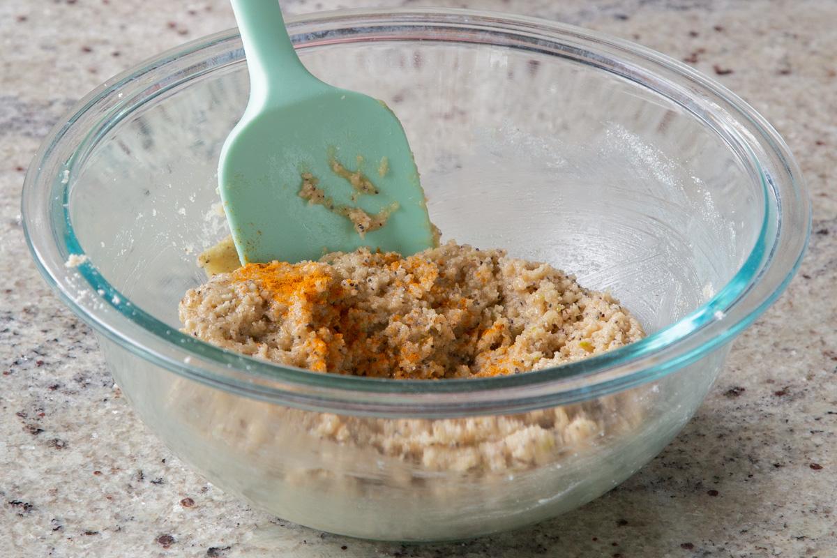 adding turmeric to the mixed lemon cookie dough