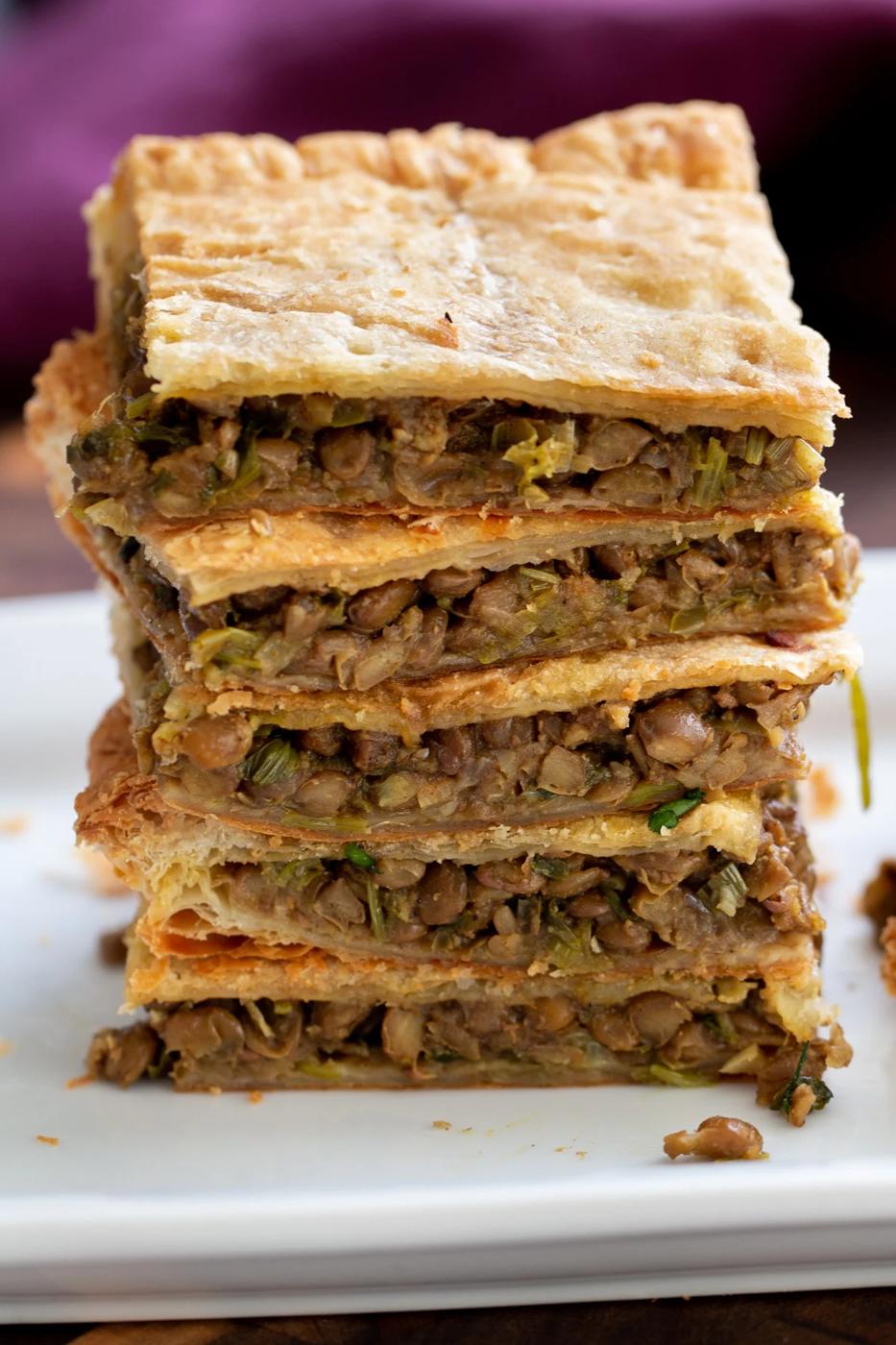 vegan lentil pie squares stacked on a white plate