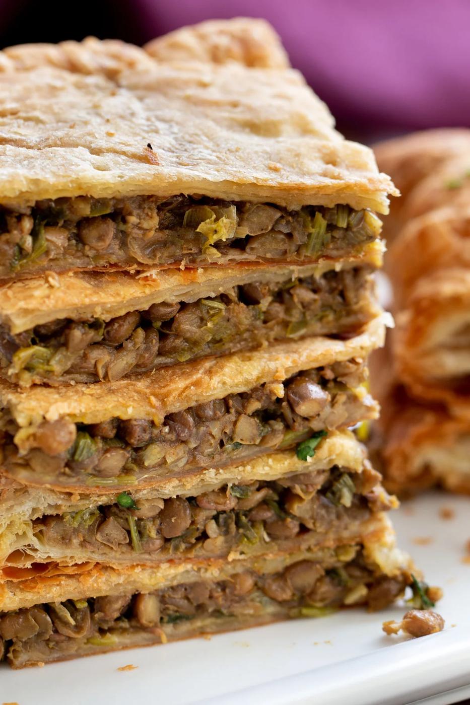 stacked vegan sambusa on a white plate
