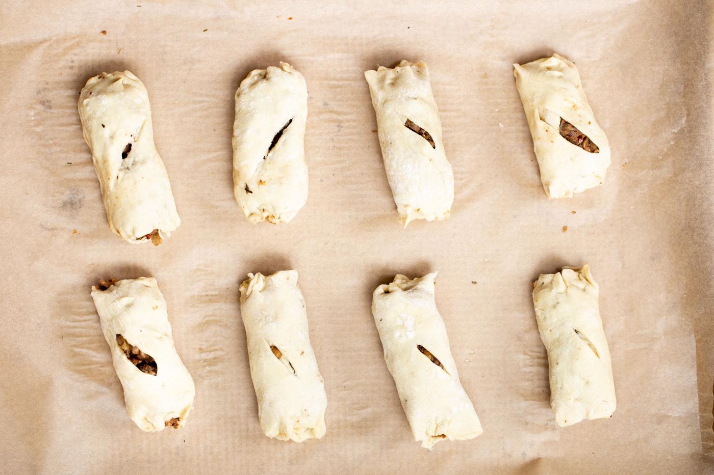 vegan sausage rolls on a sheet of parchment paper