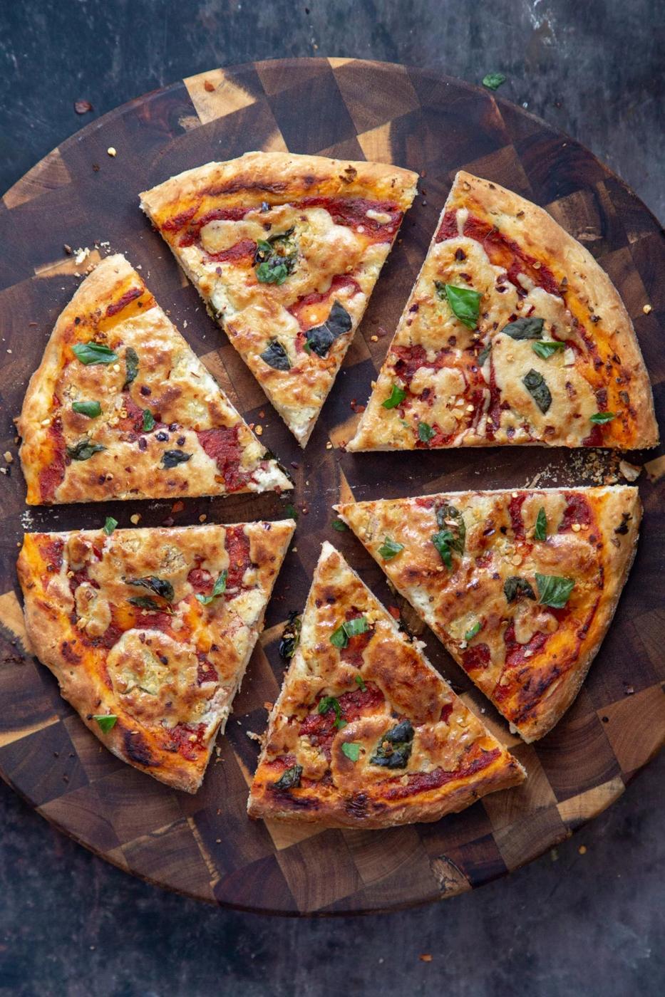 overhead shot of a vegan mozzarella pizza topped with basil