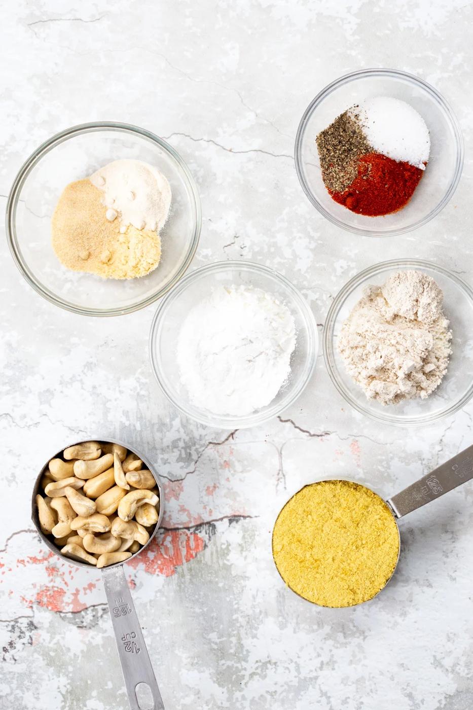 Ingredients for our Vegan Mac and cheese Powder in bowls and measuring cups