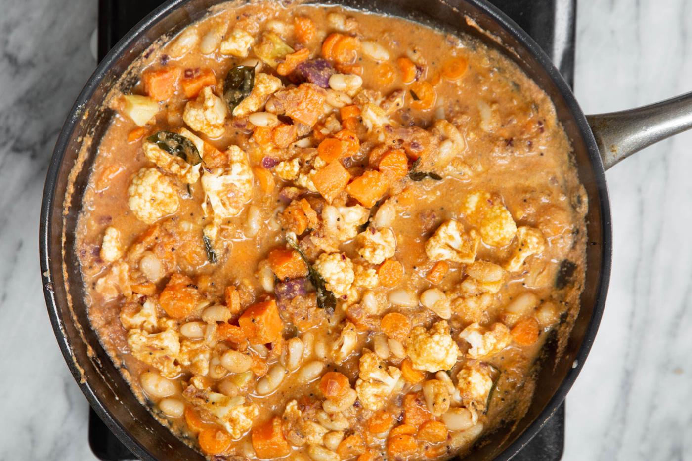 vegan malabar curry with veggies simmered in a skillet