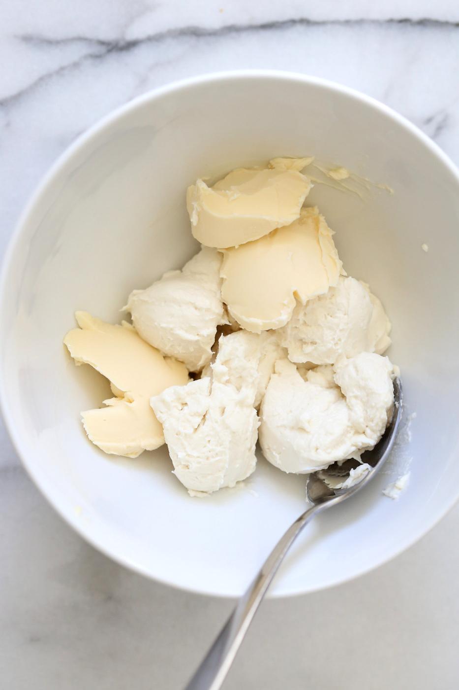 Making our Vegan Malai Burfi- Whipping Cream cheese and butter in a white bowl
