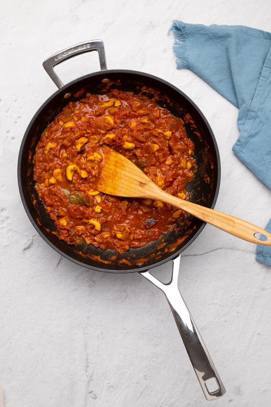 overhead shot of vegan malai kofta gravy in a black skillet