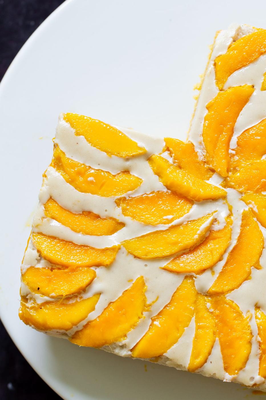 overhead photo of mango tiramisu with a slice cut out of it