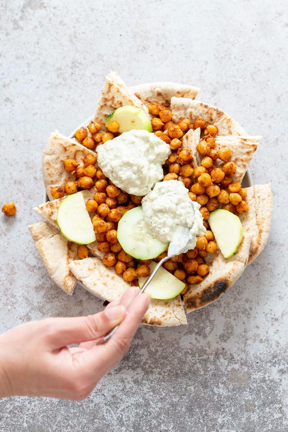 Pita bread, shawarma chickpeas and tzatziki plated for our Mediterranean Nachos.