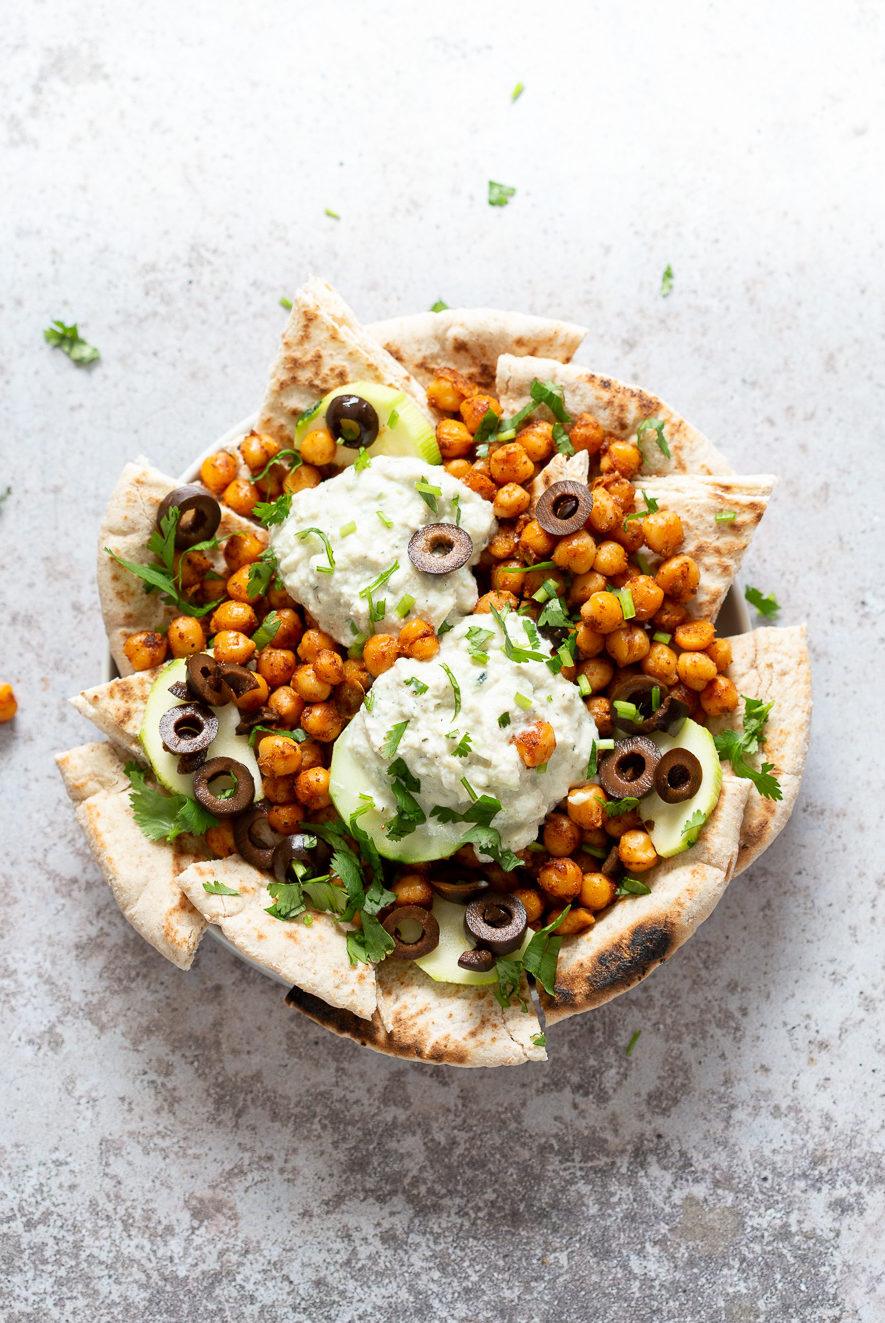 Vegan Mediterranean Nachos with Shawarma Chickpeas, Tzatziki, Olives, Pita bread