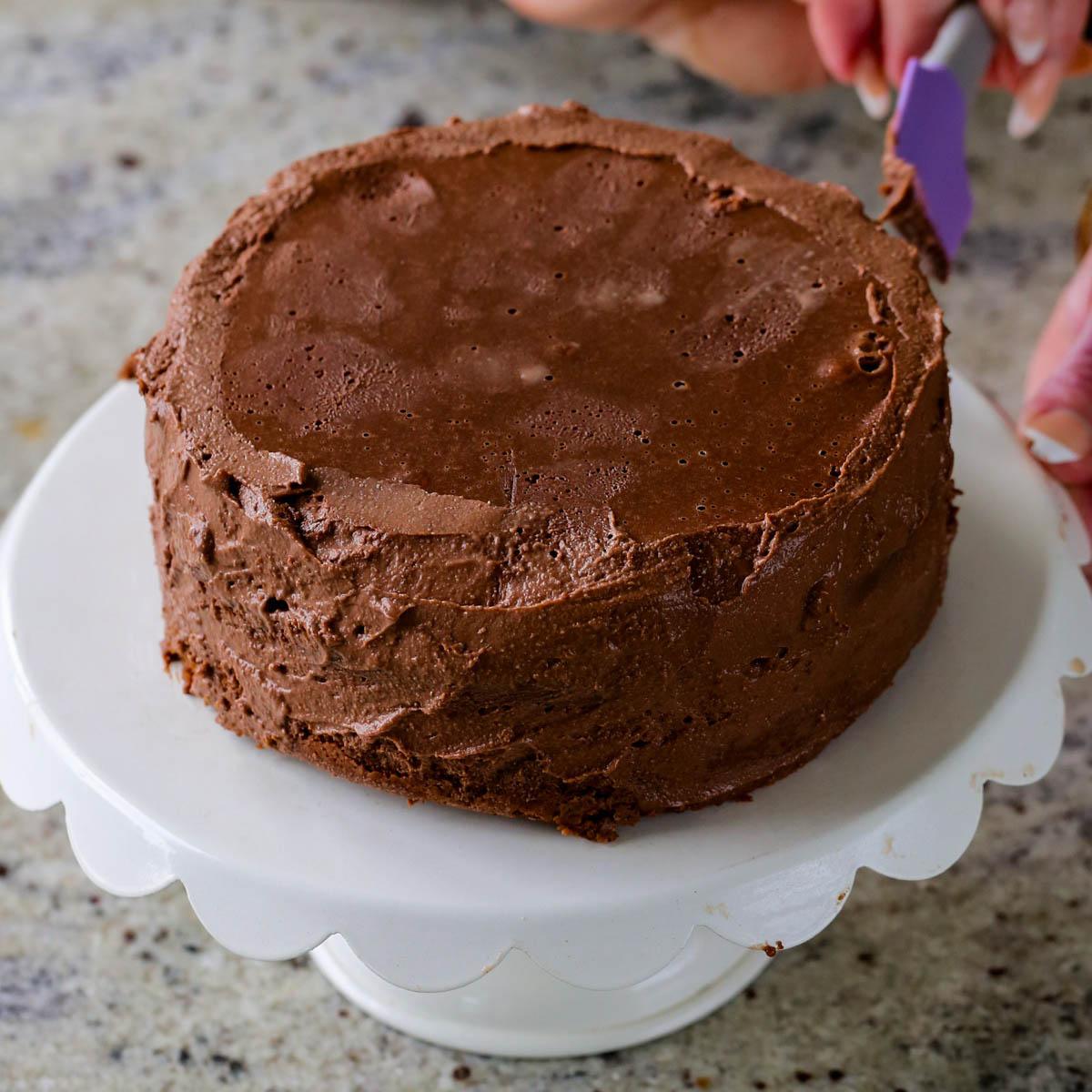 spreading frosting onto the mocha cake