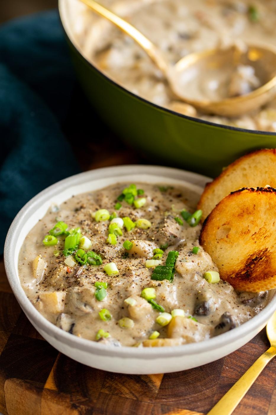 a plate of vegan mushroom chowder sprinkled with chopped spring onions
