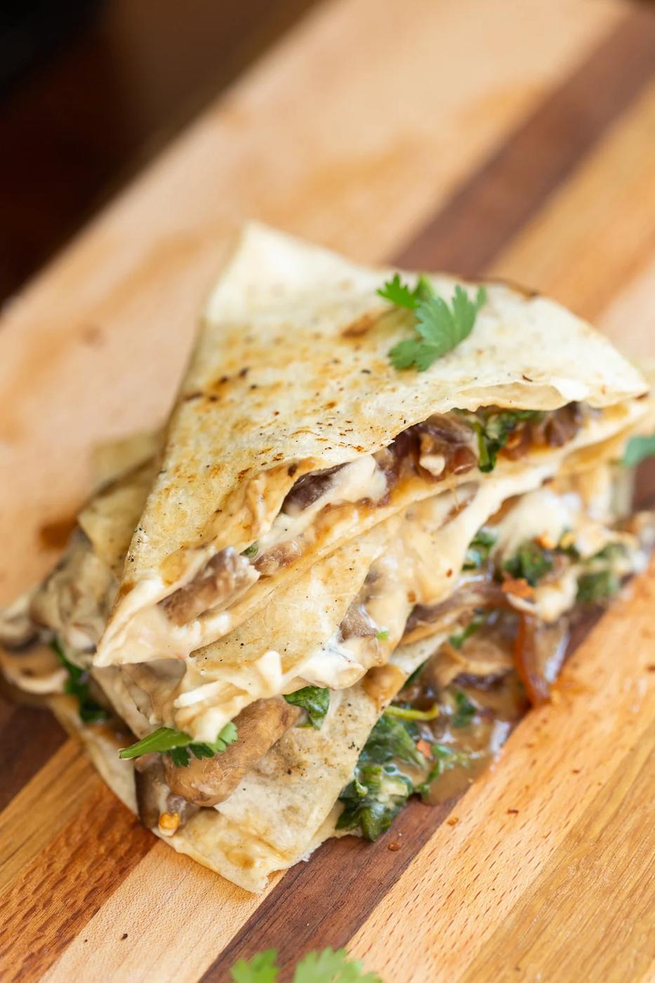Grilled and sliced Vegan Mushroom Quesadilla on Wood board