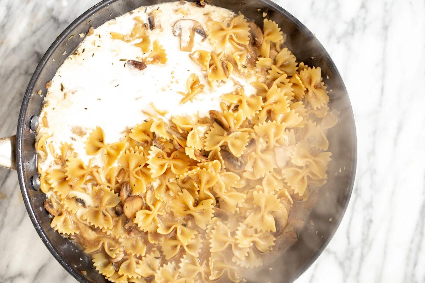 vegan cashew cream being added to mushroom stroganoff