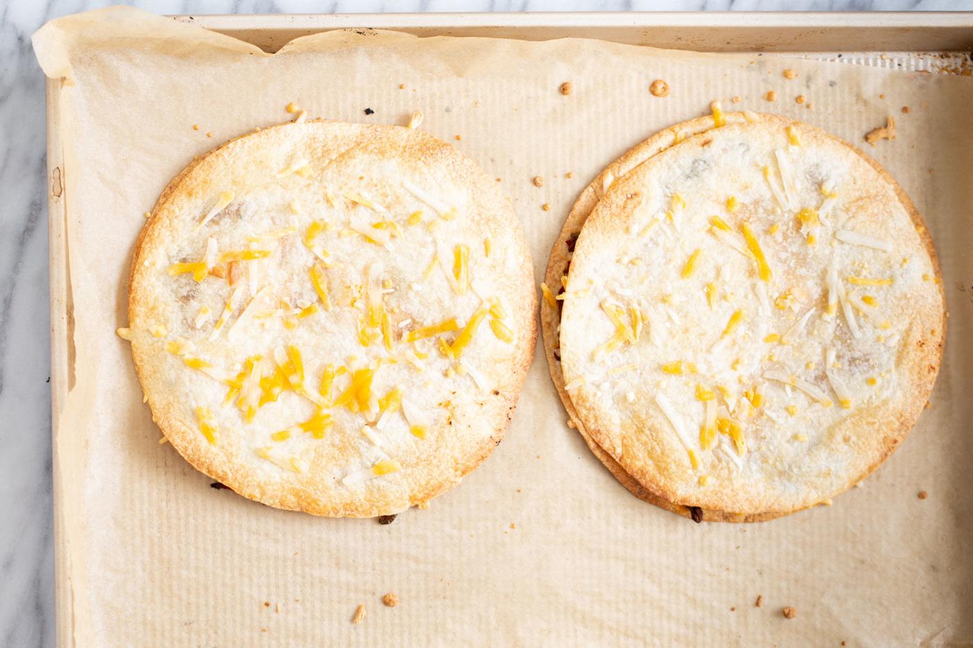Vegan Baked mushroom pepper quesadilla topped with shredded vegan cheese