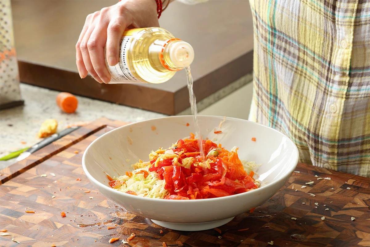 adding rice vinegar to the veggies