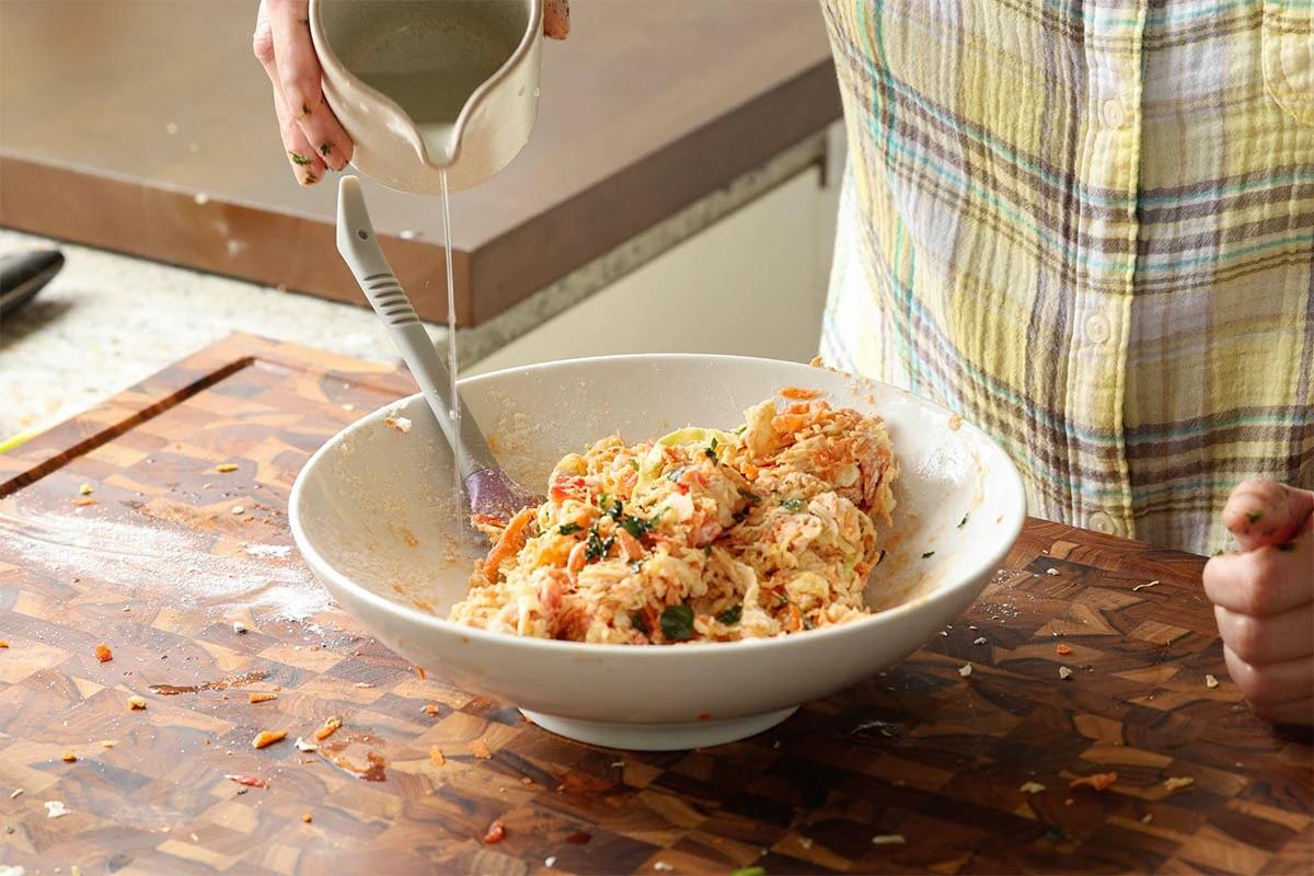 adding water to the savory pancake batter