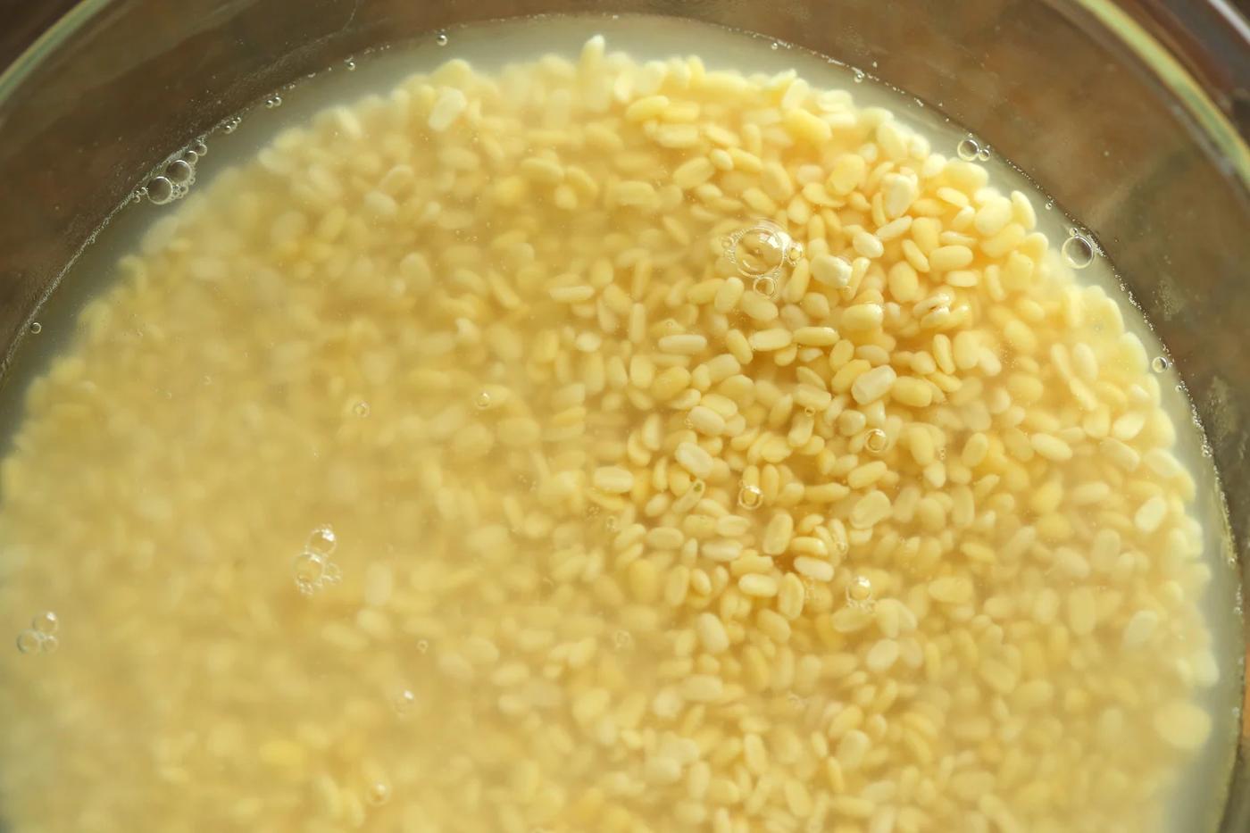 Soaked Moong Dal in a glass bowl