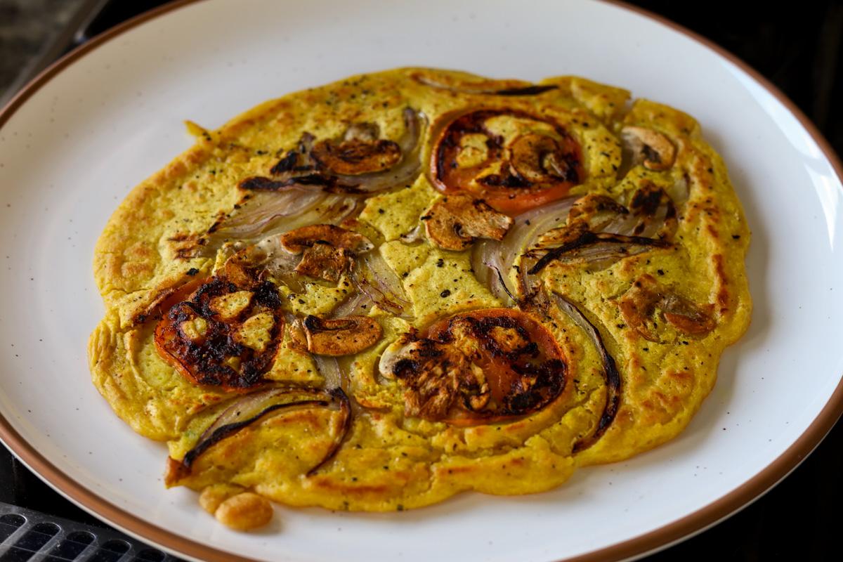 chickpea omelette prepared with the veggies inside