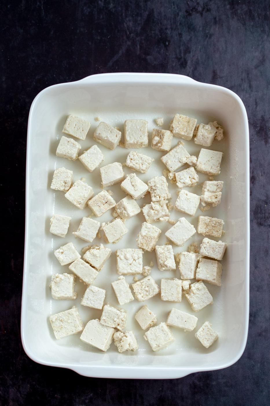 Tofu cubes in a white baking dish for our Orange Tofu Recipe