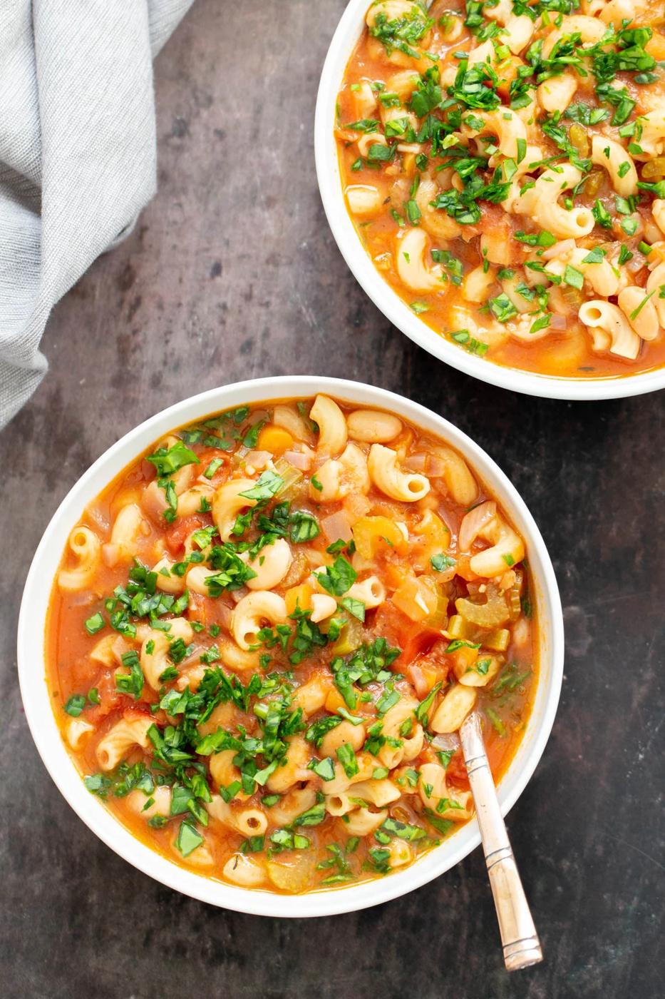overhead shot of two bowls of vegan pasta e fagioli soup