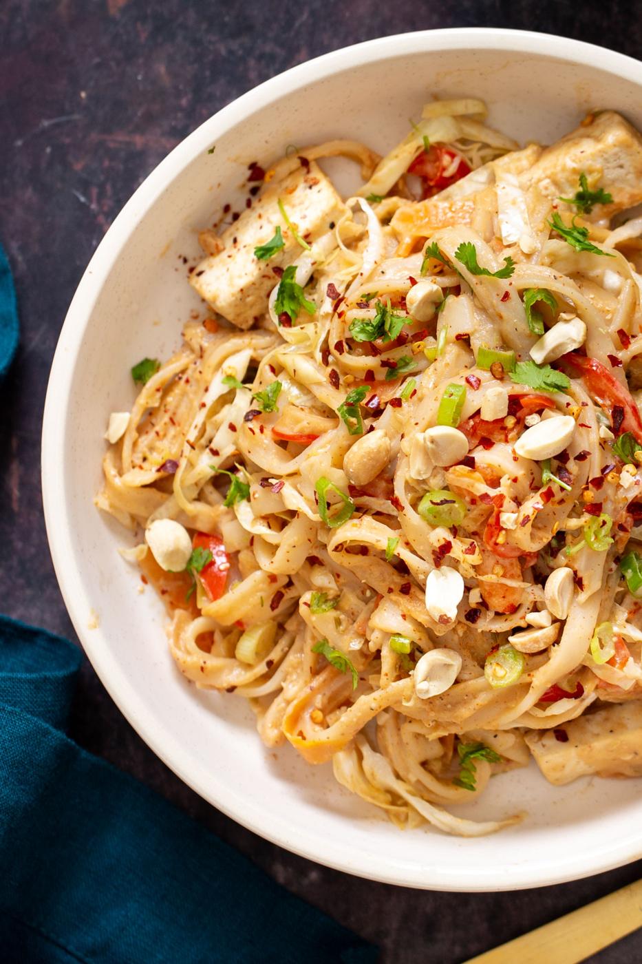 baked peanut butter noodles casserole with tofu in a serving bowl
