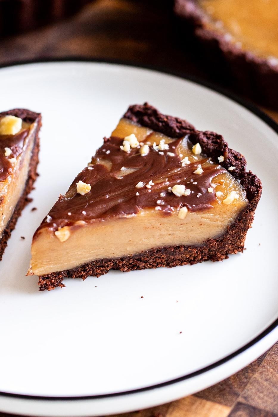 a slice of peanut butter chocolate tart on a white plate