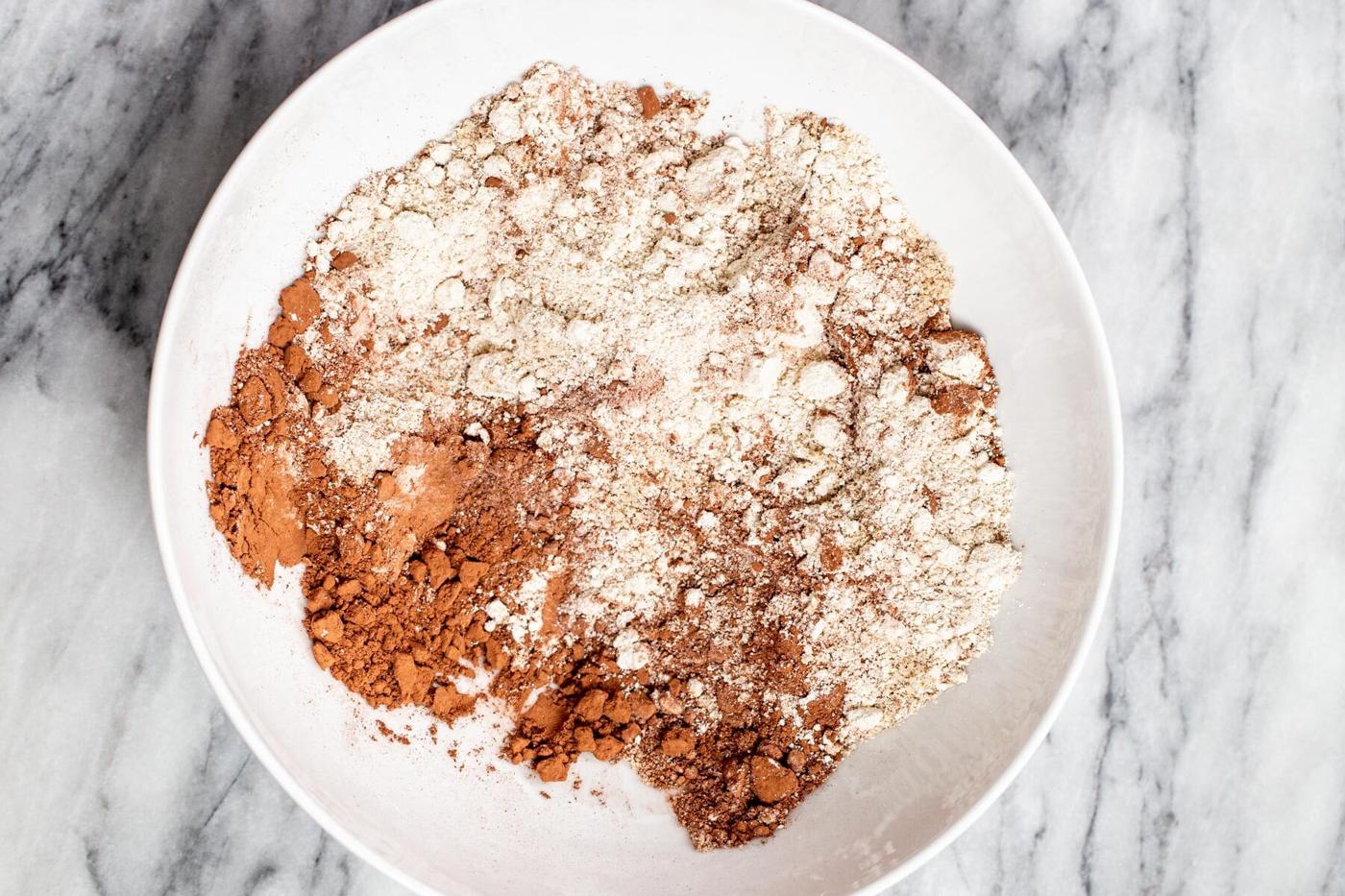 dry ingredients for peanut butter chocolate tart shell in a white bowl