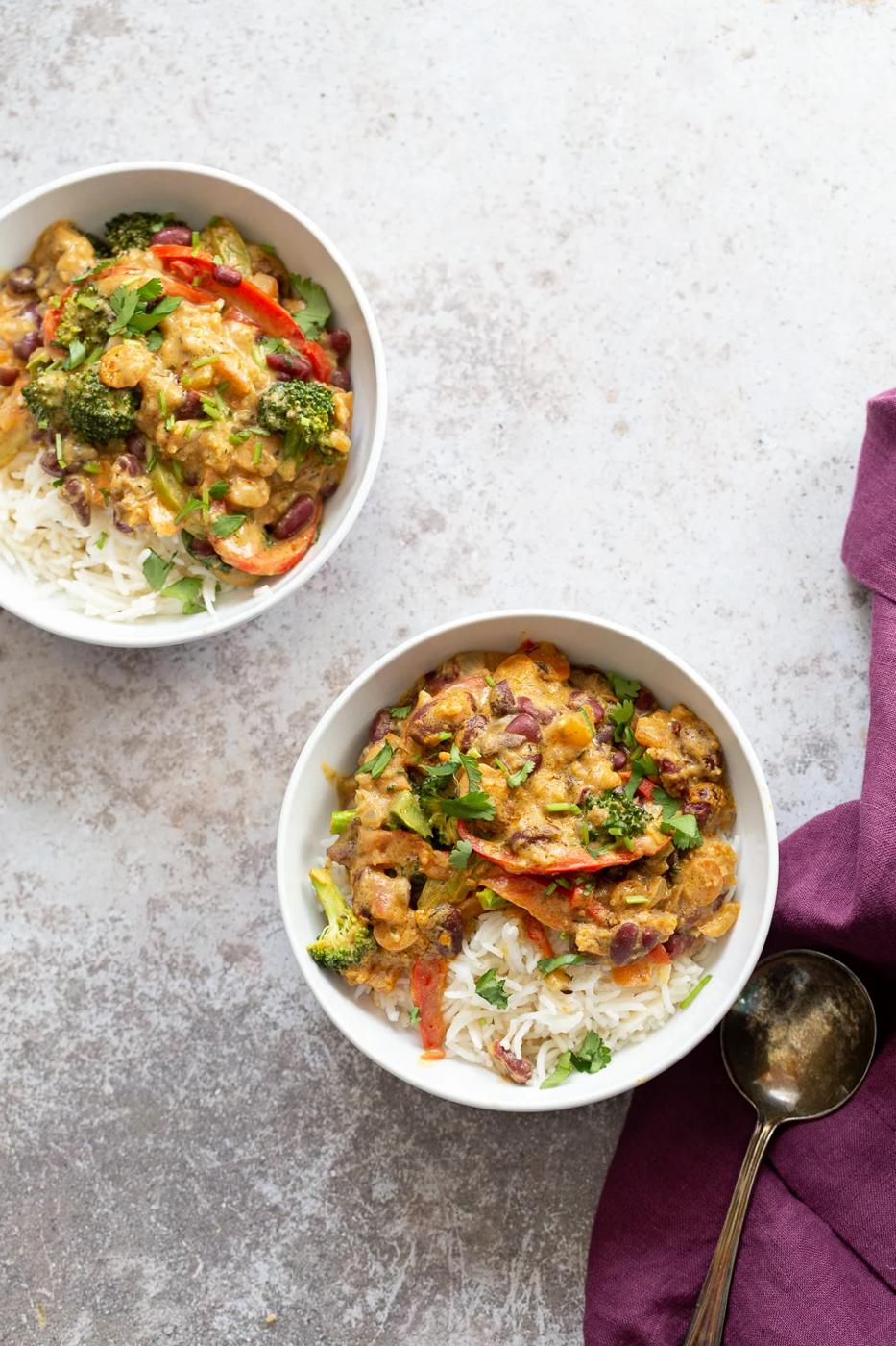 overhead shot of two bowl with vegan coconut milk based Peanut Stew served with rice