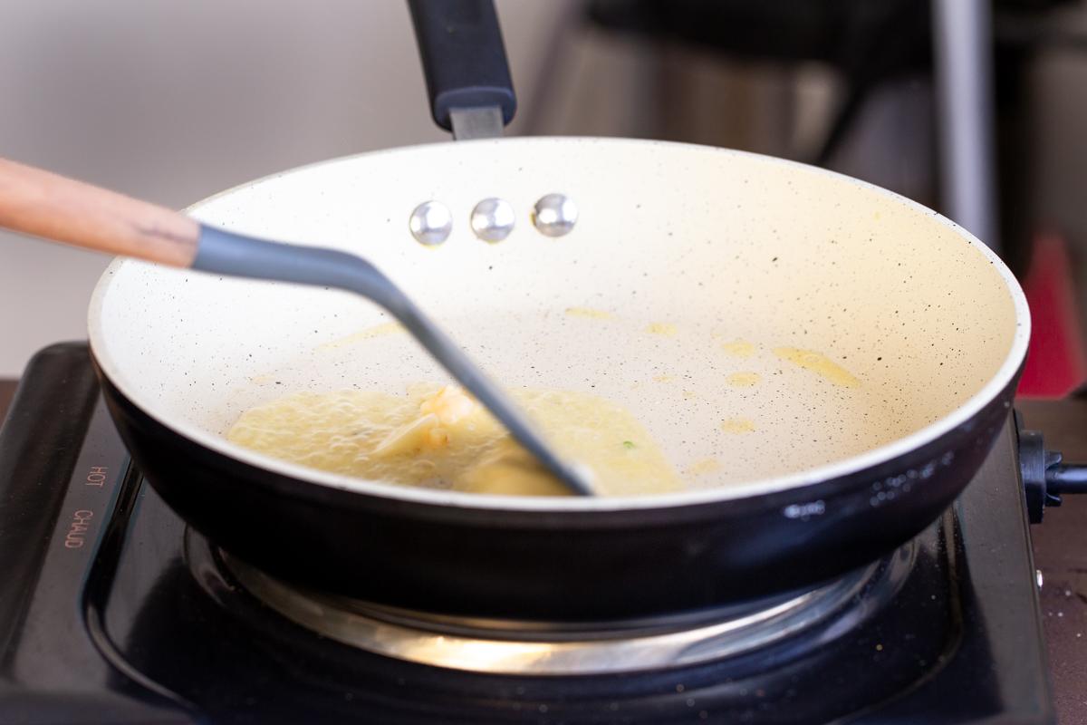 vegan butter being added to a frying pan
