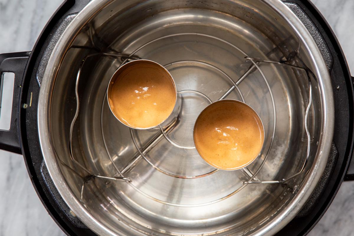 two cans with vegan sausage batter being steamed in an Instant Pot to make pepperoni