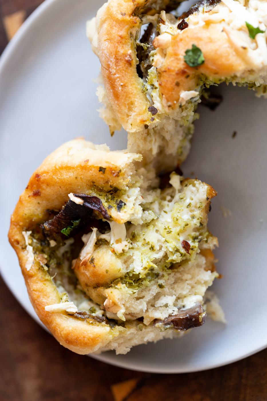 a fluffy and soft homemade Vegan Pesto Pizza roll being torn into two pieces