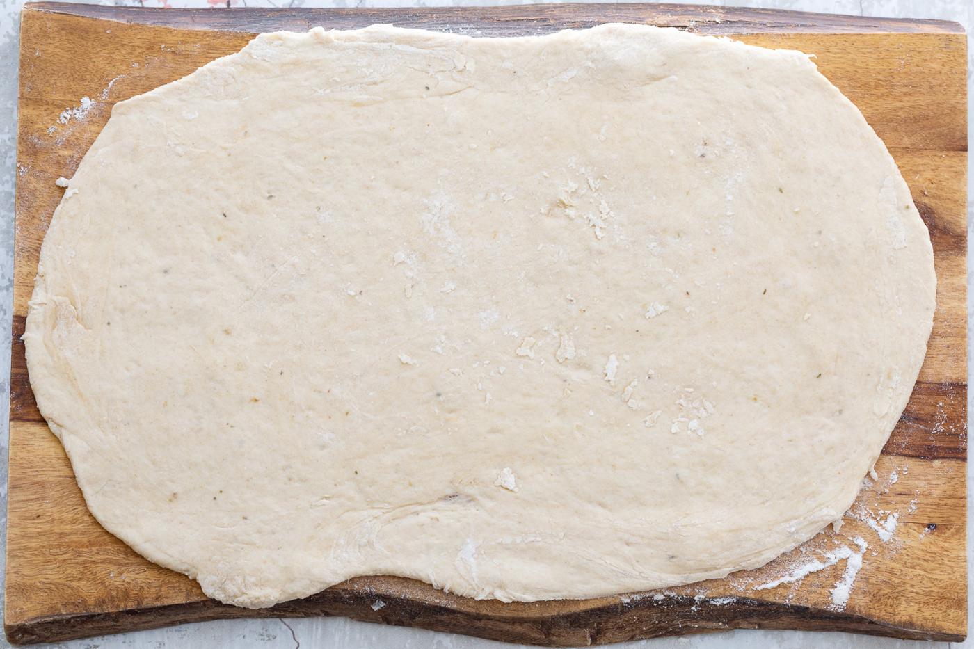 Vegan Pizza rolls dough being rolled out into a rectangle