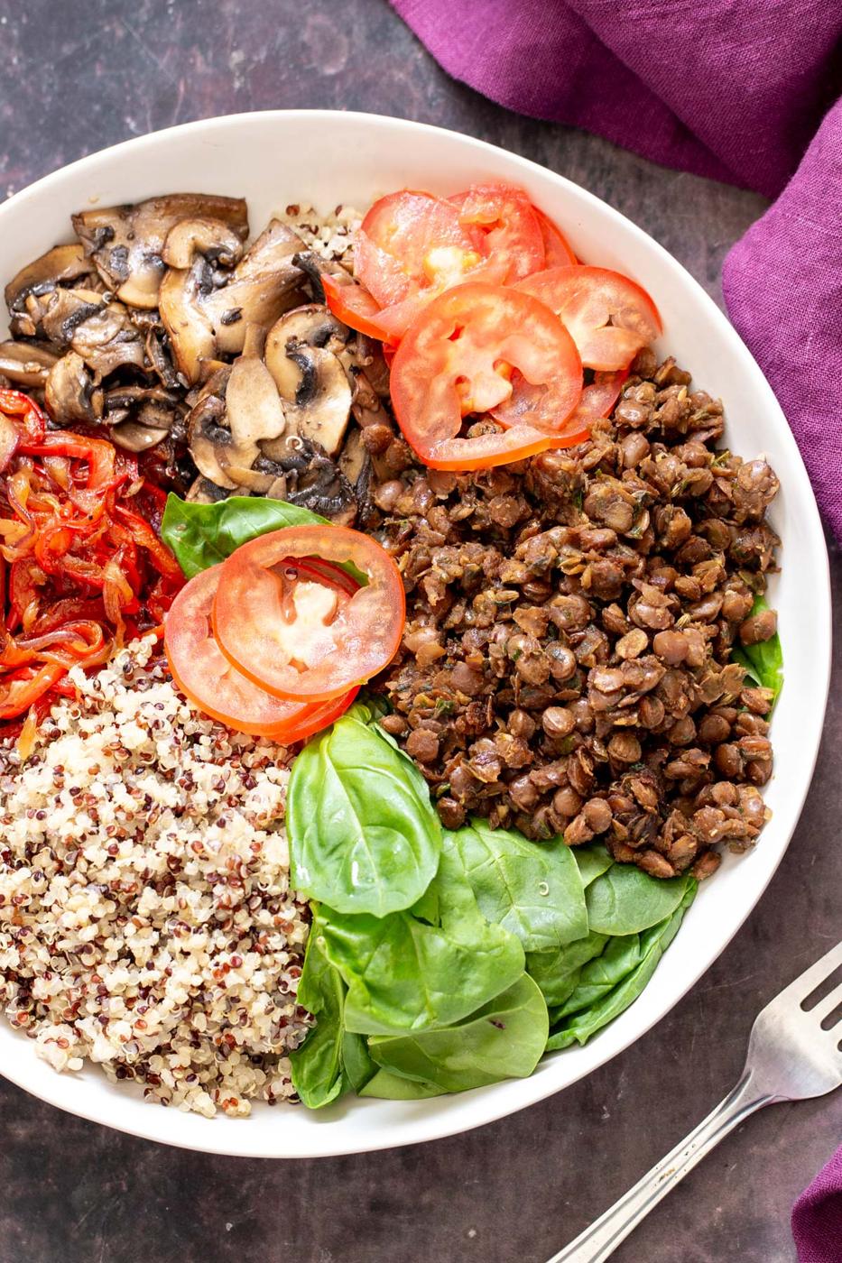 vegan pizza bowls being assembled with quinoa, veggies and lentil meat