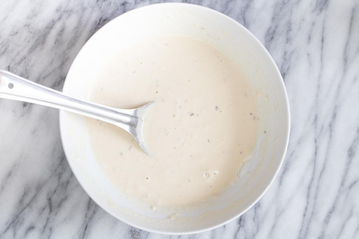 vegan pizza waffles batter being mixed in a bowl