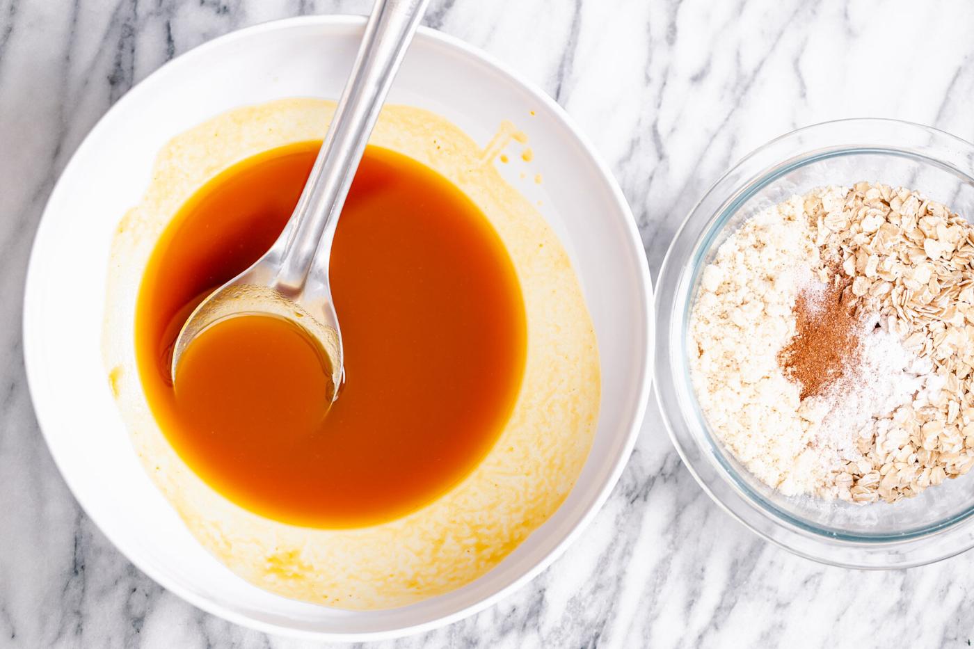 dry and liquid ingredients for pumpkin breakfast cookies in two seperate bowls