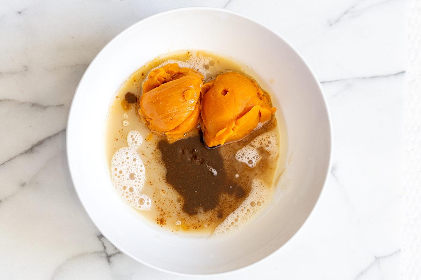 wet ingredients for vegan pumpkin bread in a white bowl