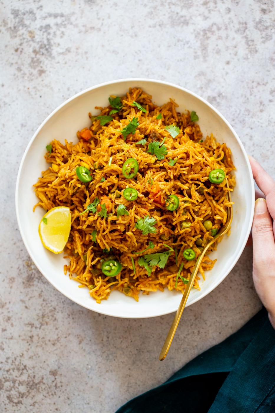 pumpkin fried rice served with sliced of lime and jalapenos