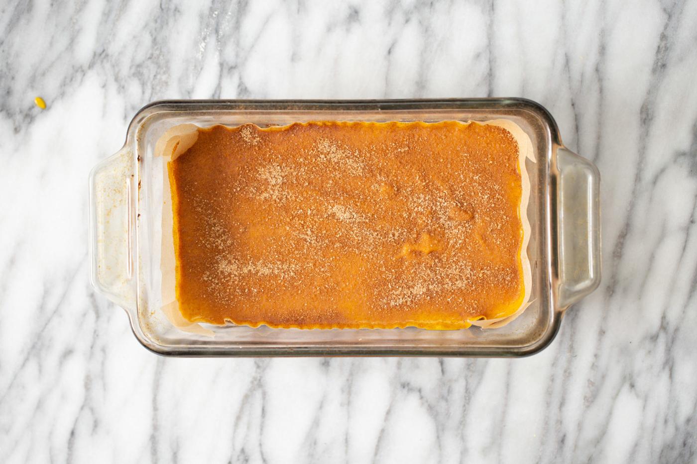 pumpkin pie filling being added to crust in loaf pan