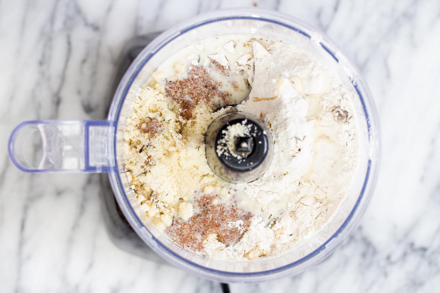 flax egg being added to vegan pie pastry in food processor