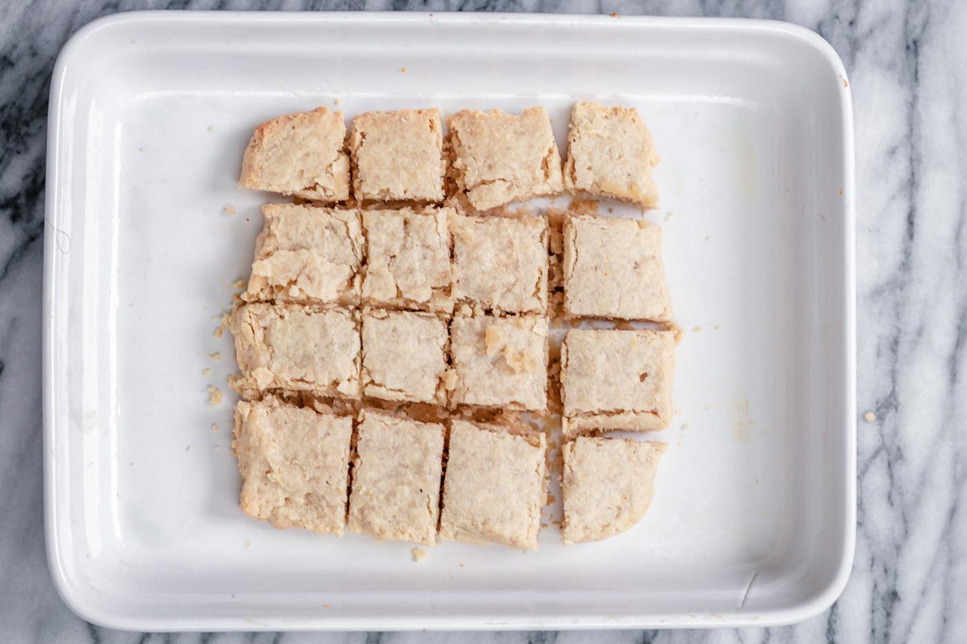 vegan rasmalai cake being cut into squares