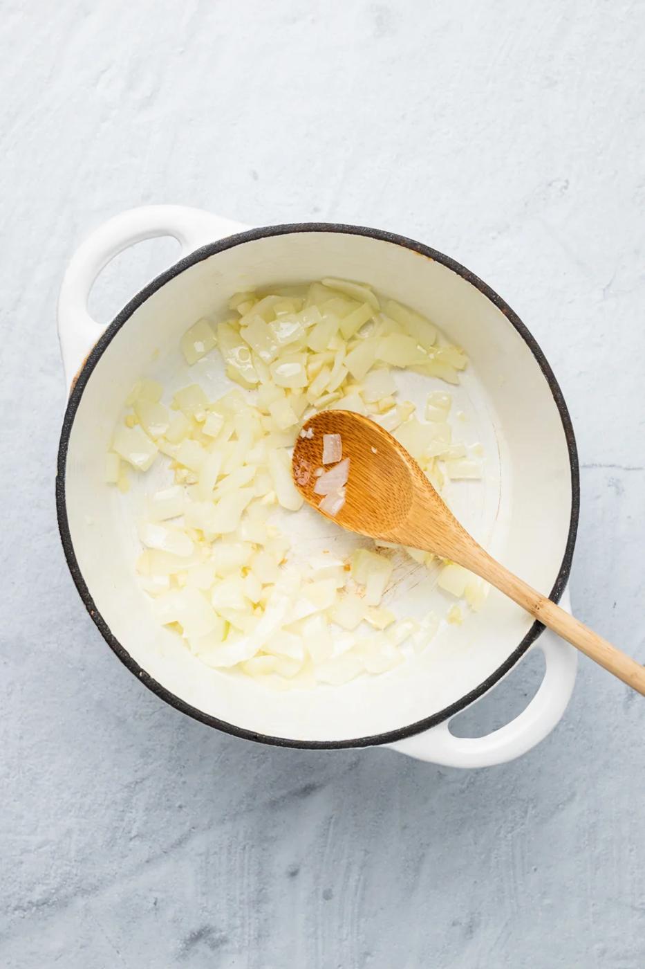 onions being sauteed in a pot