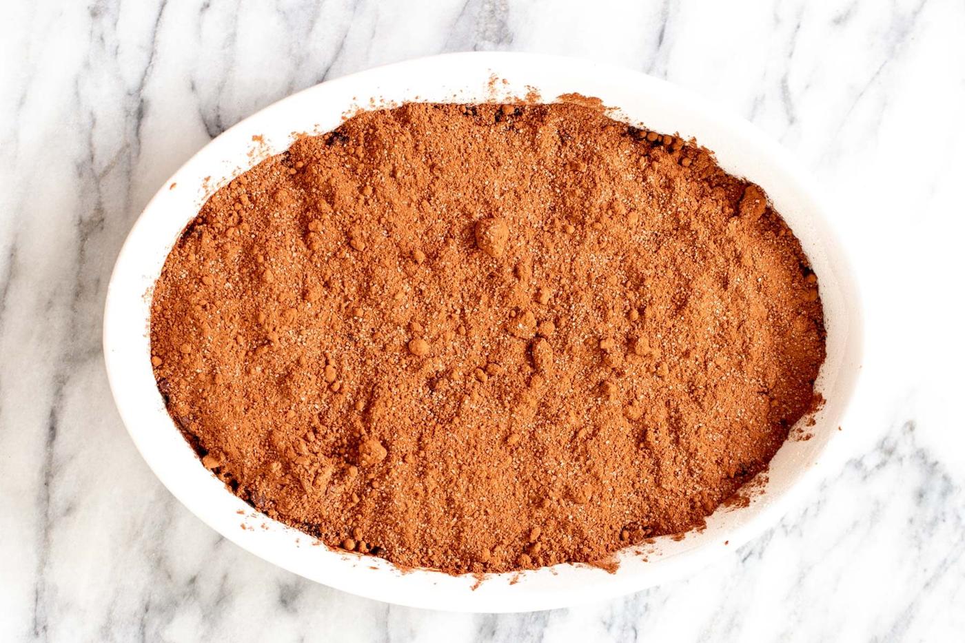 cocoa and sugar sprinkled on top of chocolate batter