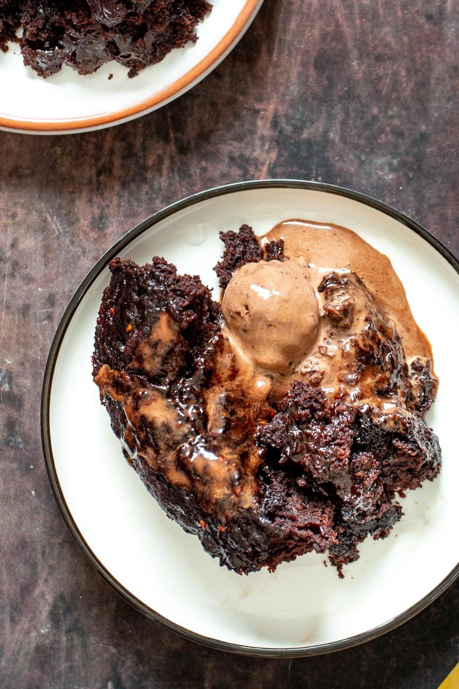 a serving of chocolate pudding cake served with a scoop of ice cream