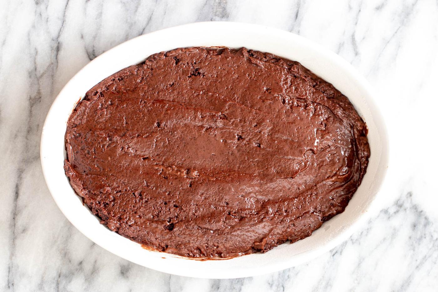vegan chocolate pudding cake batter in a round casserole dish