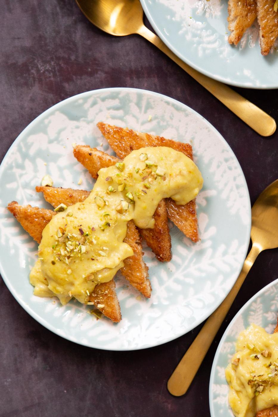 sliced toast covered with custard topped with pistachios