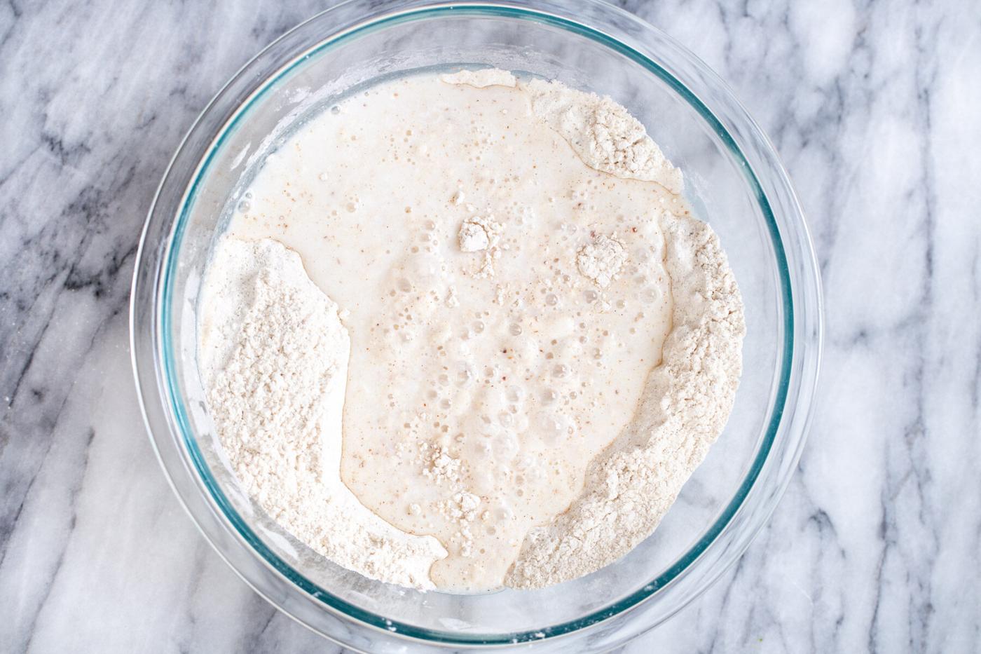 wet and dry ingredients for vegan sheet pan pancakes in a glass bowl