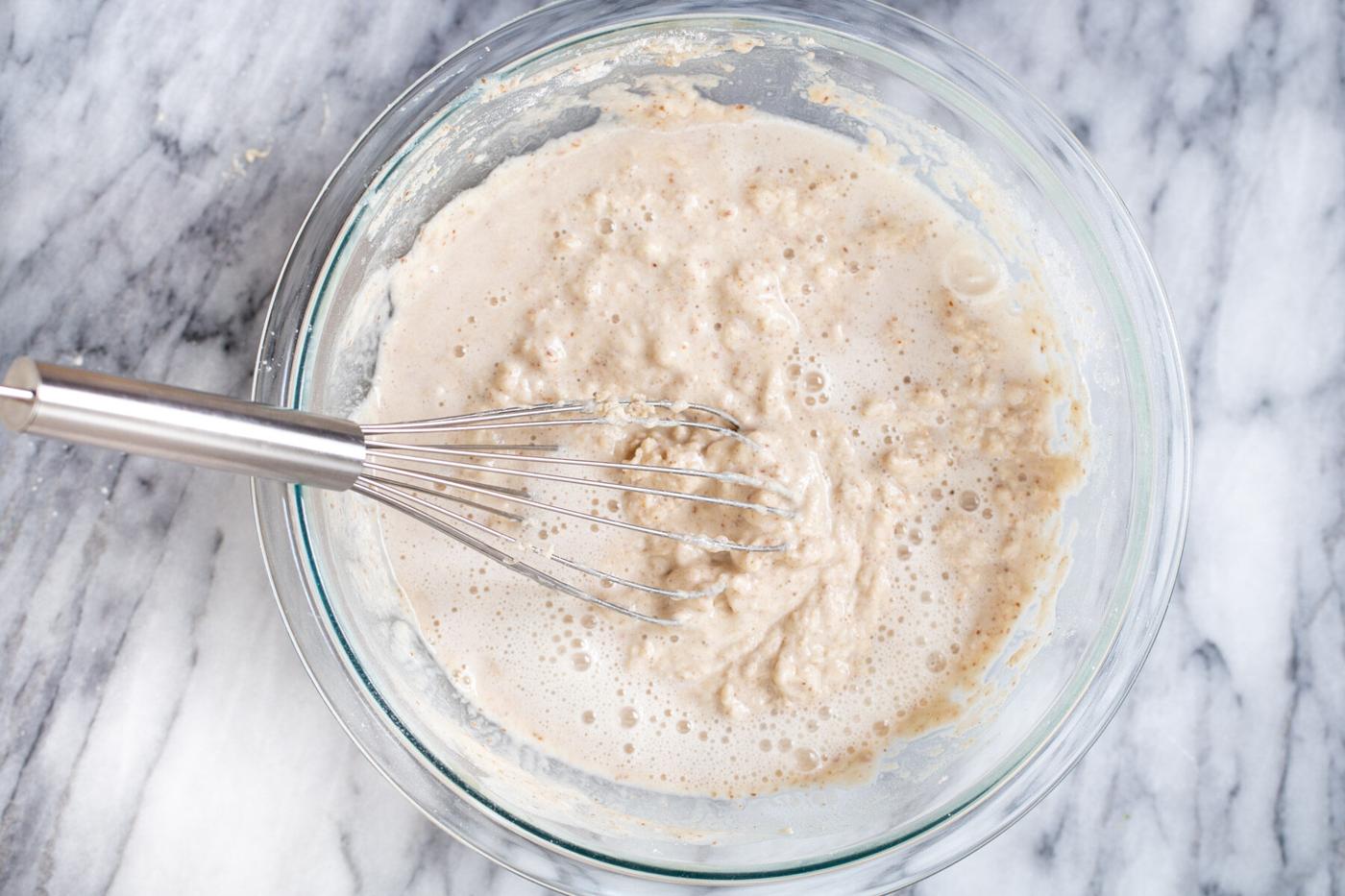 club soda being added to pancake batter to make sheet pan pancakes