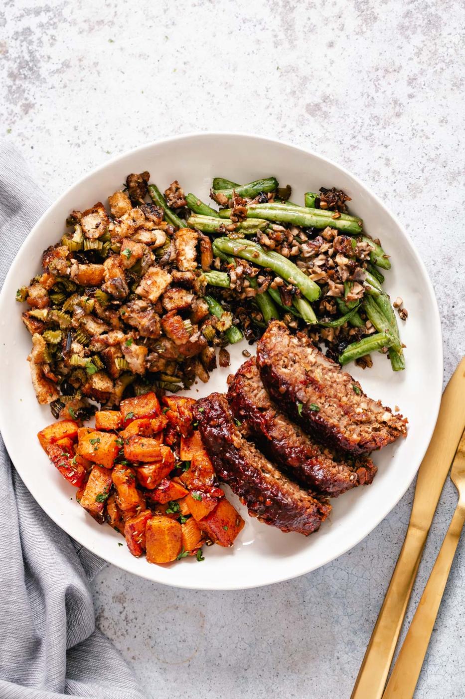 vegan lentil loaf, sweet potatoes and green beans on a plate