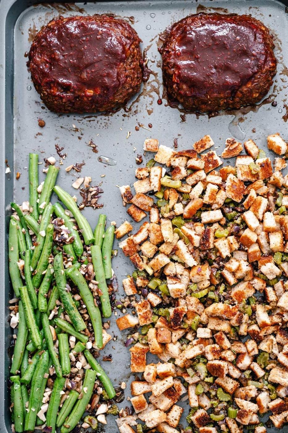 Thanksgiving sheet pan dinner - green beans and stuffing next to two lentil loaves